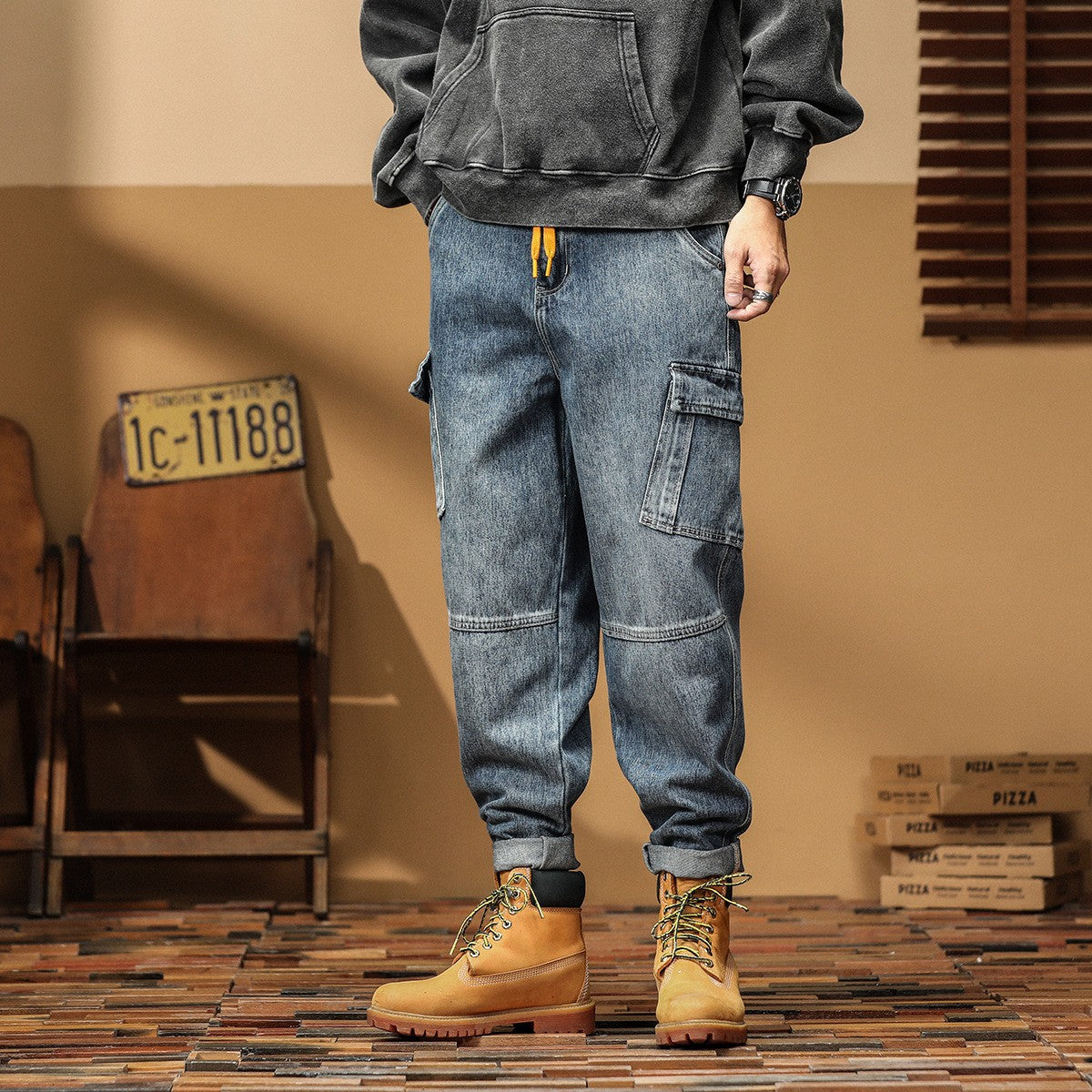Man wearing utility jeans in a rugged indoor workwear setting